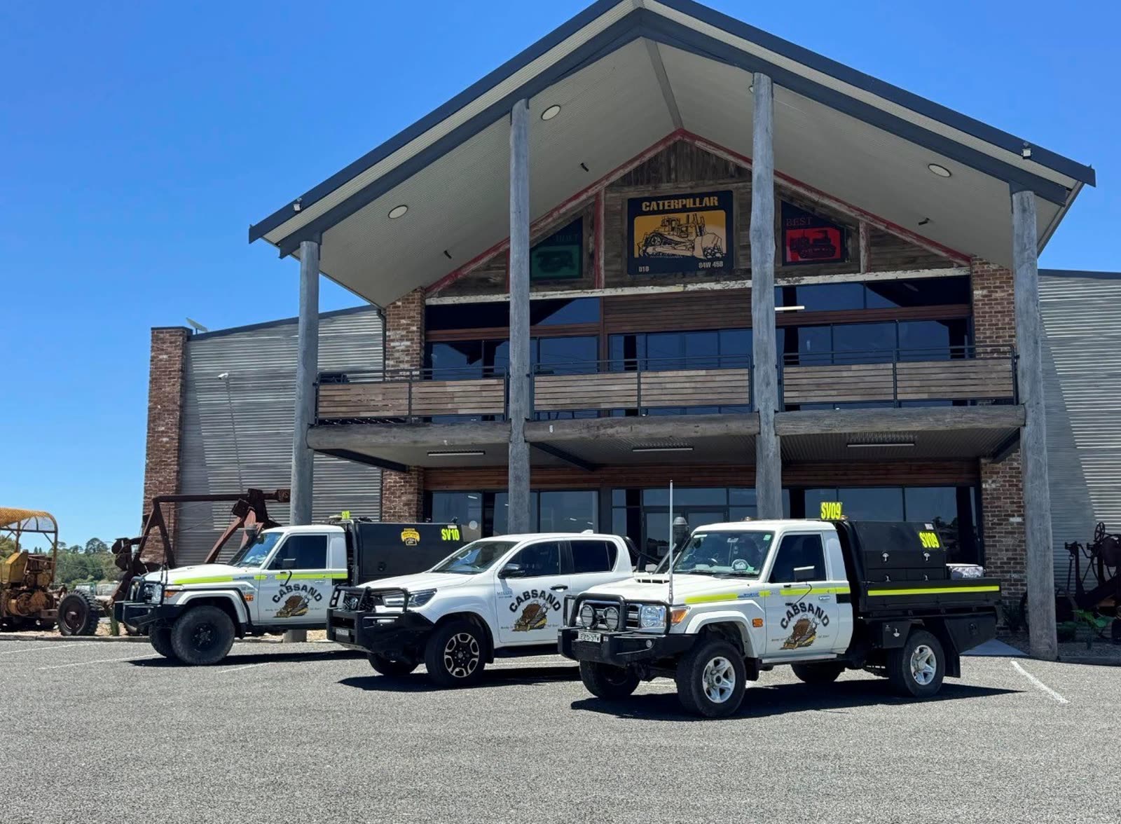 CABSAND headquarters in Orange NSW with three branded service utes parked out front