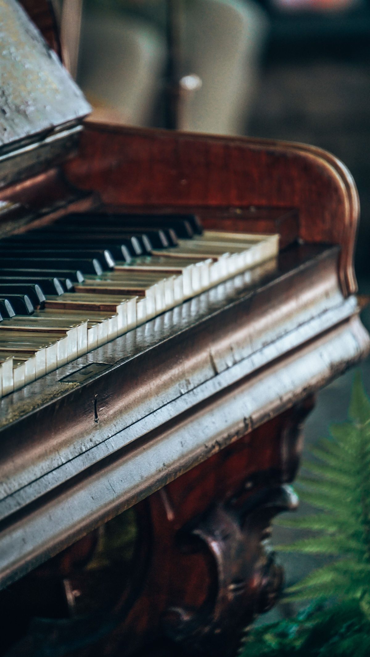 Worn ivory keys and the aged timber of an old upright piano
