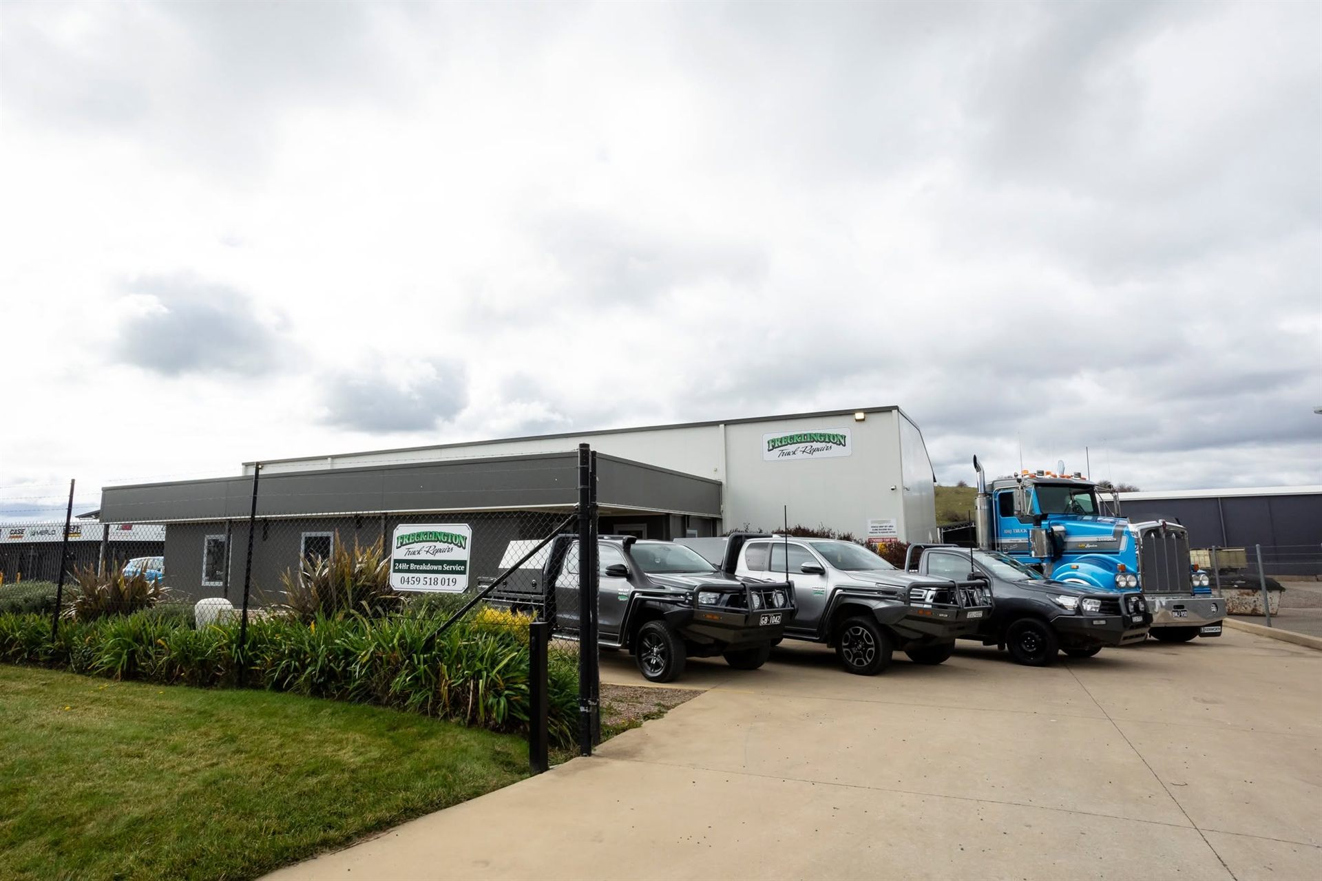 Frecklington Truck Repairs workshop in Orange with service utes and a Kenworth out front